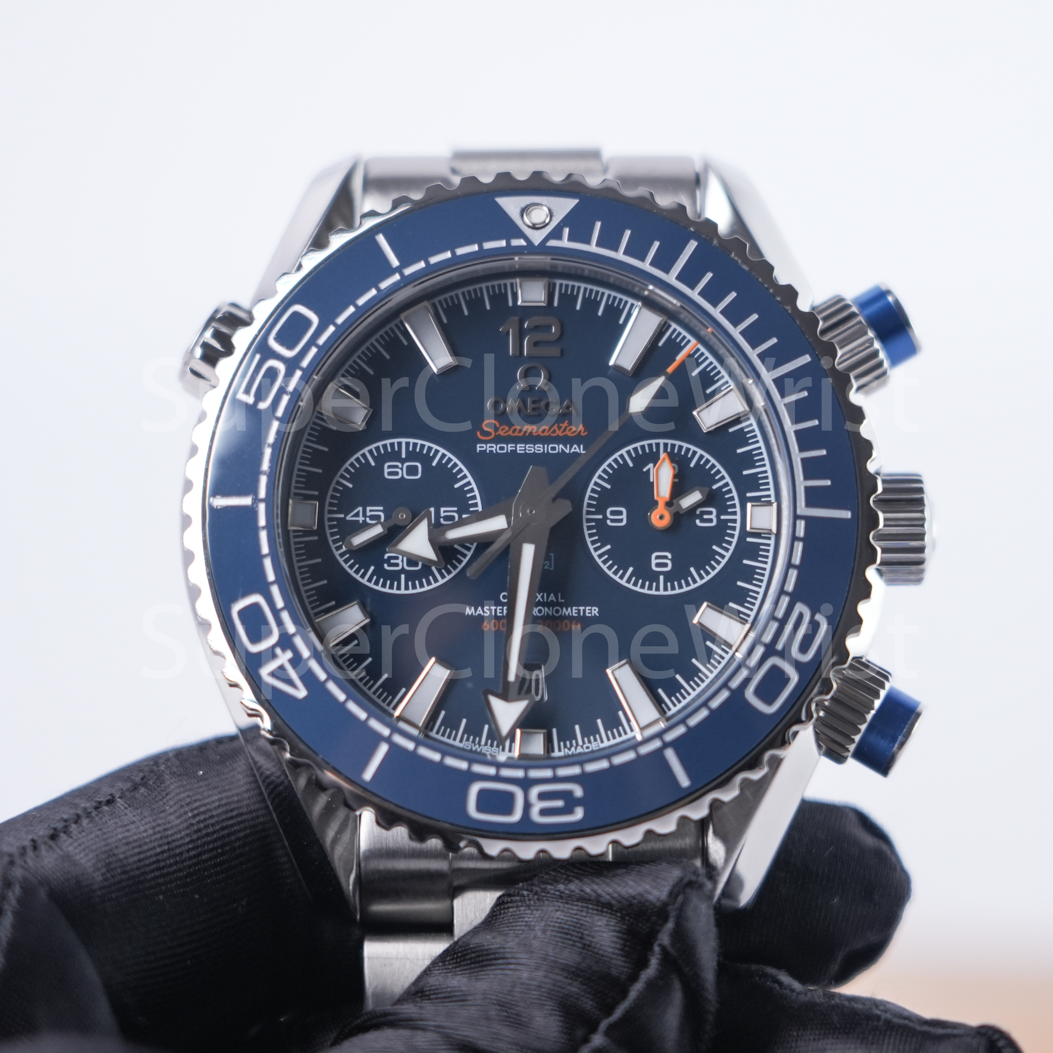 Omega Seamaster Planet Ocean 600M Chronograph blue dial blue ceramic bezel and steel bracelet held with a black glove